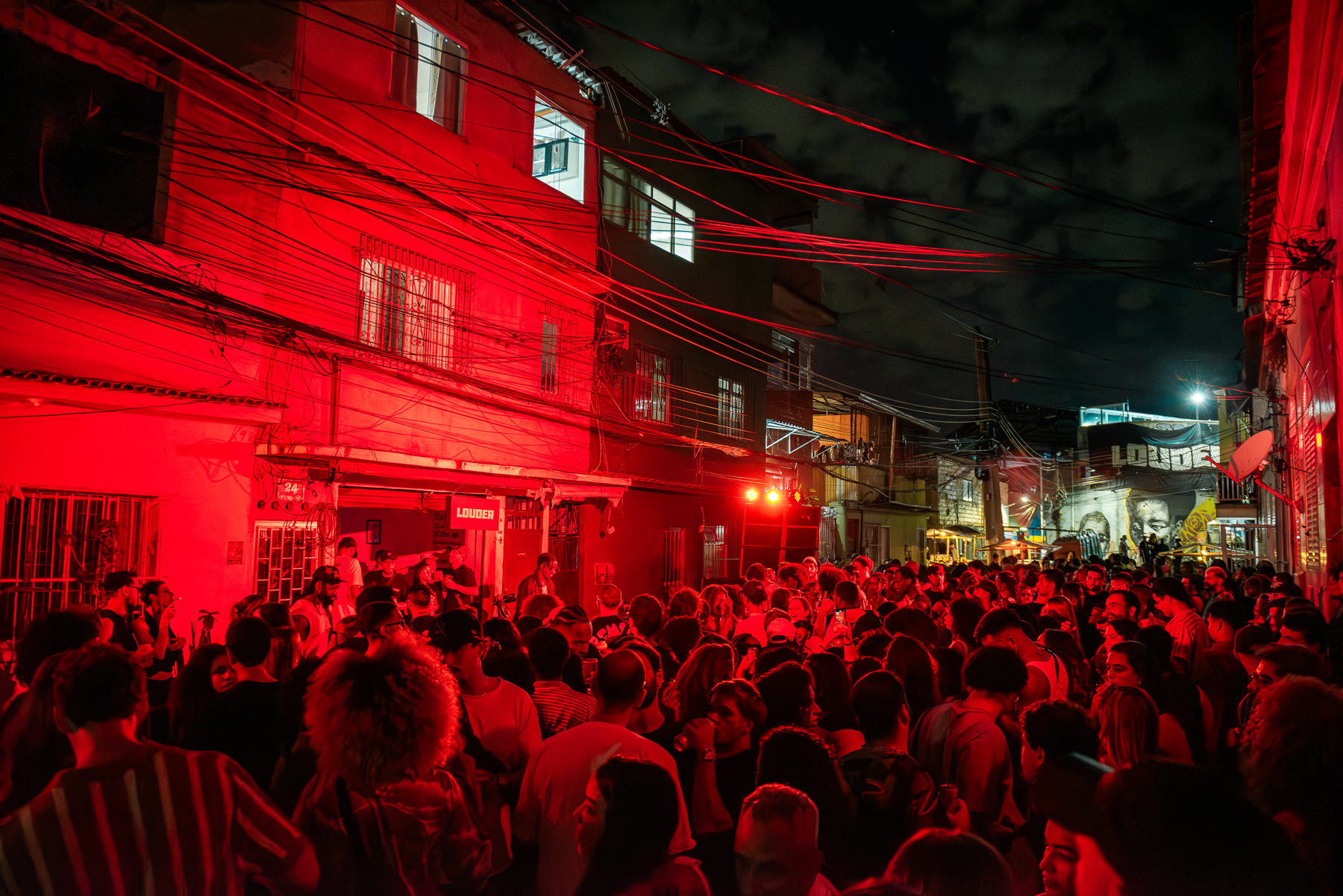 Rua lotada sob luz vermelha